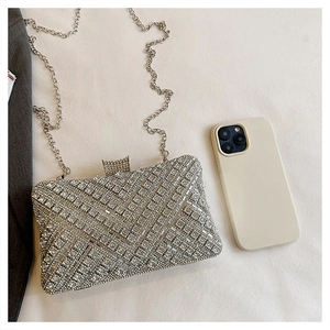 Detailed view of silver rhinestone evening clutch bag with geometric crystal pattern
