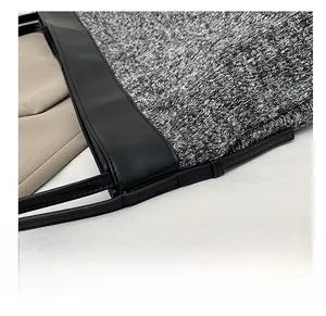 Close-up of tight stitching detail on the mixed wool and black leather tote bag
