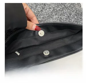 Detail of wool tote showing secure magnetic snap closure and smooth black inner lining