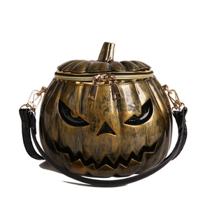 Realistic pumpkin crossbody bag in black and gold finish with a jack-o-lantern face