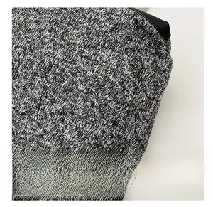 Macro shot of high-quality mixed grey knit wool fabric with durable leather piping detail