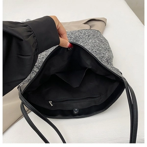 Detail view of tweed tote bag interior with zipper pocket and magnetic snap closure