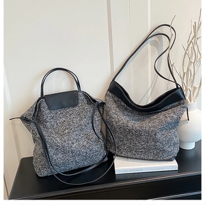 Detail of grey wool blend tote and crescent shoulder bags with black leather trim