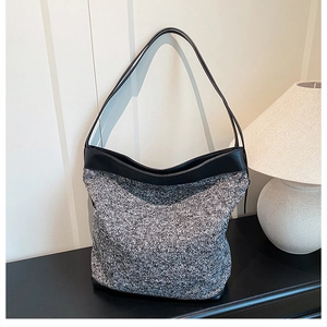 Detail of the high-quality grey knit fabric texture and premium black leather handle