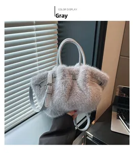 Detailed view of gray faux fur plush handbag with leather handle and strap