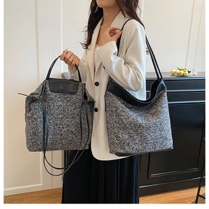 Detail of tweed tote bag featuring premium leather trim and sturdy shoulder straps