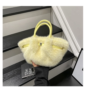 Close-up of lemon yellow faux fur plush handbag with fluffy texture and gold metal buckle