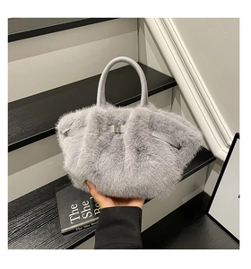 Close-up of fluffy grey faux fur handbag texture with elegant metal hardware detailing