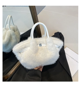 Detail showing plush white faux fur texture and elegant silver metal buckle on the bag