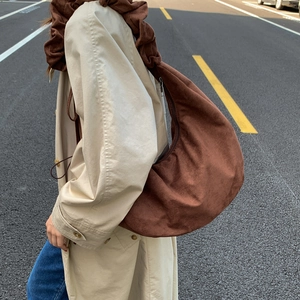 Brown suede crescent underarm bag with scrunchie strap for autumn winter fashion look
