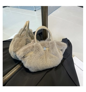 Detail shot of plush faux fur handbag with elegant silver metal buckle and soft texture