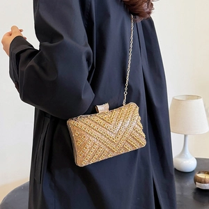 Elegant gold rhinestone evening clutch bag with V-shaped crystal patterns and chain strap