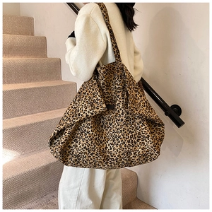 Lifestyle shot of large leopard print tote bag being worn on a woman's shoulder