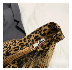 Close-up of leopard print canvas tote bag featuring premium silver metal zipper hardware