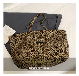 Detailed close-up of large leopard print tote bag with leopard pattern and carry handles