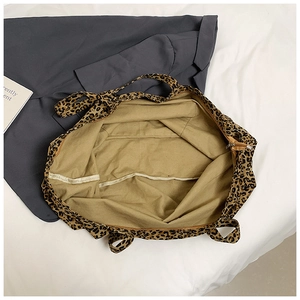 Detailed top view showing the wide zip closure and light brown inner lining of the tote bag
