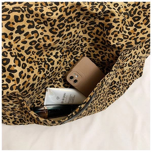 Macro view of leopard print canvas tote bag showing spacious interior and thick texture