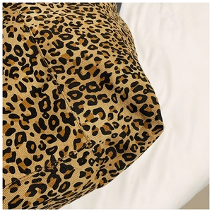 Detailed close-up showing reinforced stitching and leopard print twill canvas fabric texture