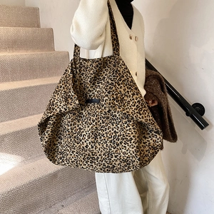 Large capacity leopard print tote bag for women shown in a stylish indoor setting