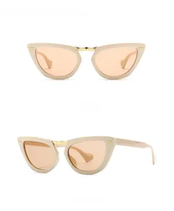 Dettaglio occhiali da sole cat-eye beige con ponte in metallo e lenti marrone chiaro