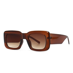 Fashionable oversized square sunglasses with amber frames and brown gradient lenses