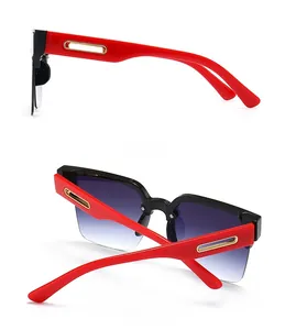 Side and back view of oversized black and red sunglasses with gold trim and gradient lenses