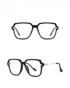 Front and 45-degree side view of oversized black square eyeglasses with gold metal accents