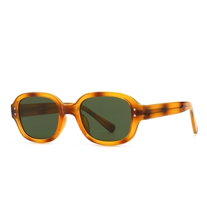 Retro tortoise shell sunglasses with dark green lenses and silver dot rivet accents