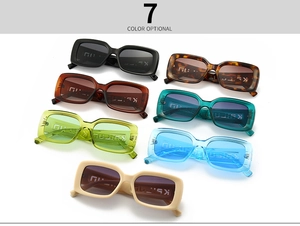 Flat lay display of thick rectangular sunglasses in seven vibrant and trendy color options