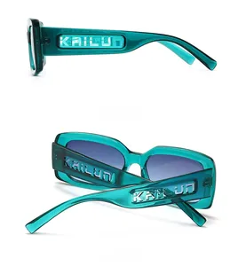 Detail showing emerald green transparent rectangular frames with hollow logo carving on temples
