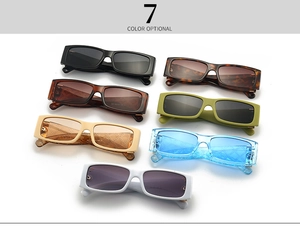 Detailed view of square sunglasses shown in seven assorted colors on a white background