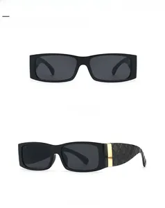Detail of square black sunglasses with quilted embossed temples and gold metal accents