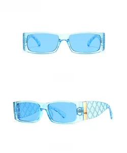 Detail of blue rectangle sunglasses with quilted texture temples and gold metal accents
