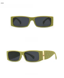 Detail view of square sunglasses featuring olive green frames and quilted temple textures