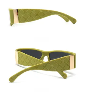 Detail view of olive green square sunglasses with quilted texture and gold metal hinges