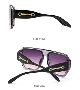 Détail de grandes lunettes de soleil grises avec ornements en métal doré sur les branches