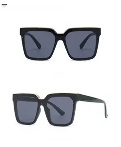 Front and 45-degree side view of oversized square sunglasses with black and gold frames
