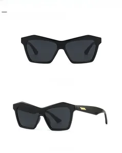 Cat eye sunglasses detail with signature golden stripe metal decor on black frames