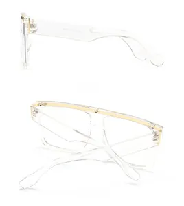 Detail view of transparent square sunglasses with gold metal top bar and size markings