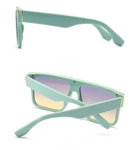 Detail view showing mint green sunglasses with stylish purple gradient lenses and gold hinges