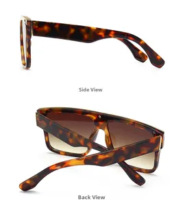 Detail view of tortoiseshell flat top sunglasses with gradient lenses and gold metal hinges