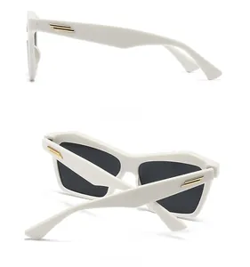 Side and back view of white cat-eye sunglasses with gold metal bar on the temples