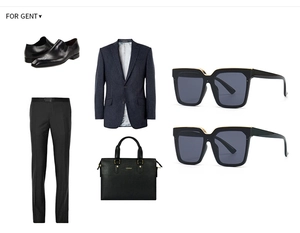 Detail of trendy square black sunglasses paired with business suit and leather bag