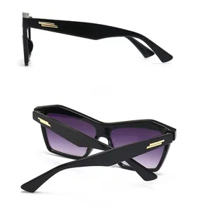 Detail of black rectangular frame with purple gradient lenses and gold temple stripes