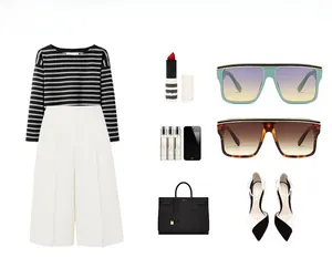 Flat lay of oversized flat top sunglasses styled with striped shirt and white trousers