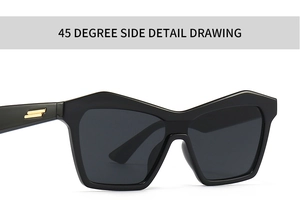 Detail view of cat eye sunglasses with black frame and golden parallel accents at 45 degree