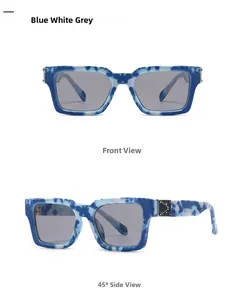Détail de lunettes de soleil carrées effet marbre avec charnières en métal doré