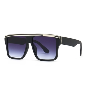 Chic oversized black square sunglasses with a golden metal brow bar and gradient lenses