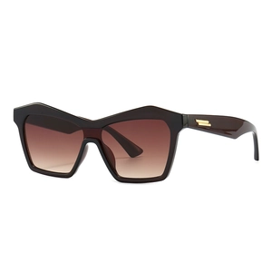 Modern cat eye sunglasses with dark frames, gradient lenses and gold temple accents