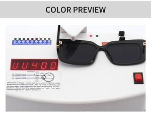 Detail showing marble pattern sunglasses with UV400 protection test on professional device
